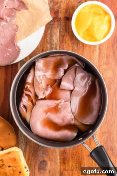 Roast beef in broth in a pot.