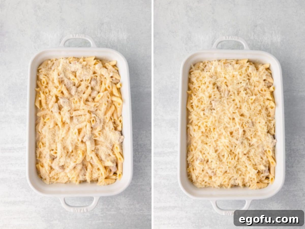Pasta bake in a pan topped with more parmesan and mozzarella cheese, ready for the oven.