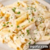 Looking down on a plate of Chicken Alfredo Casserole, ready to be eaten.