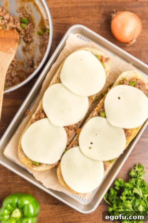 Meat and cheese on bread.