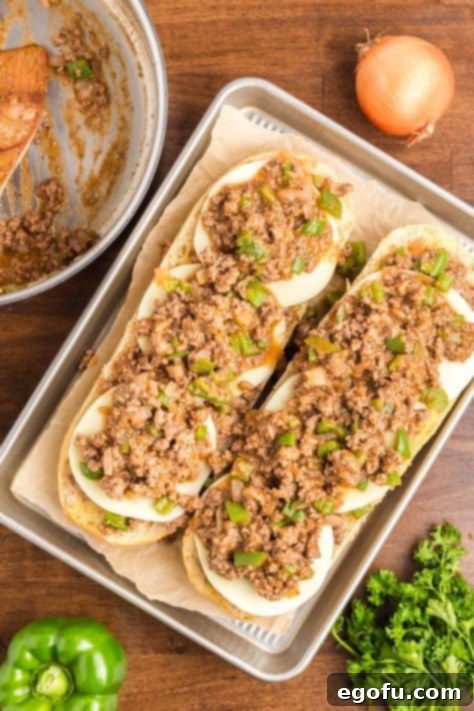 More meat being added to cheese.