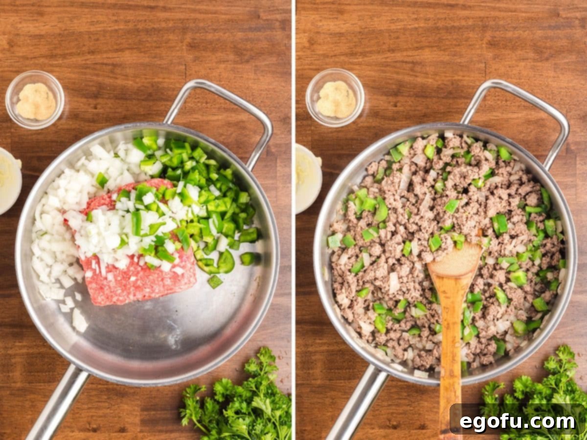 Some ground beef, onions, and peppers cooking in a skillet. 