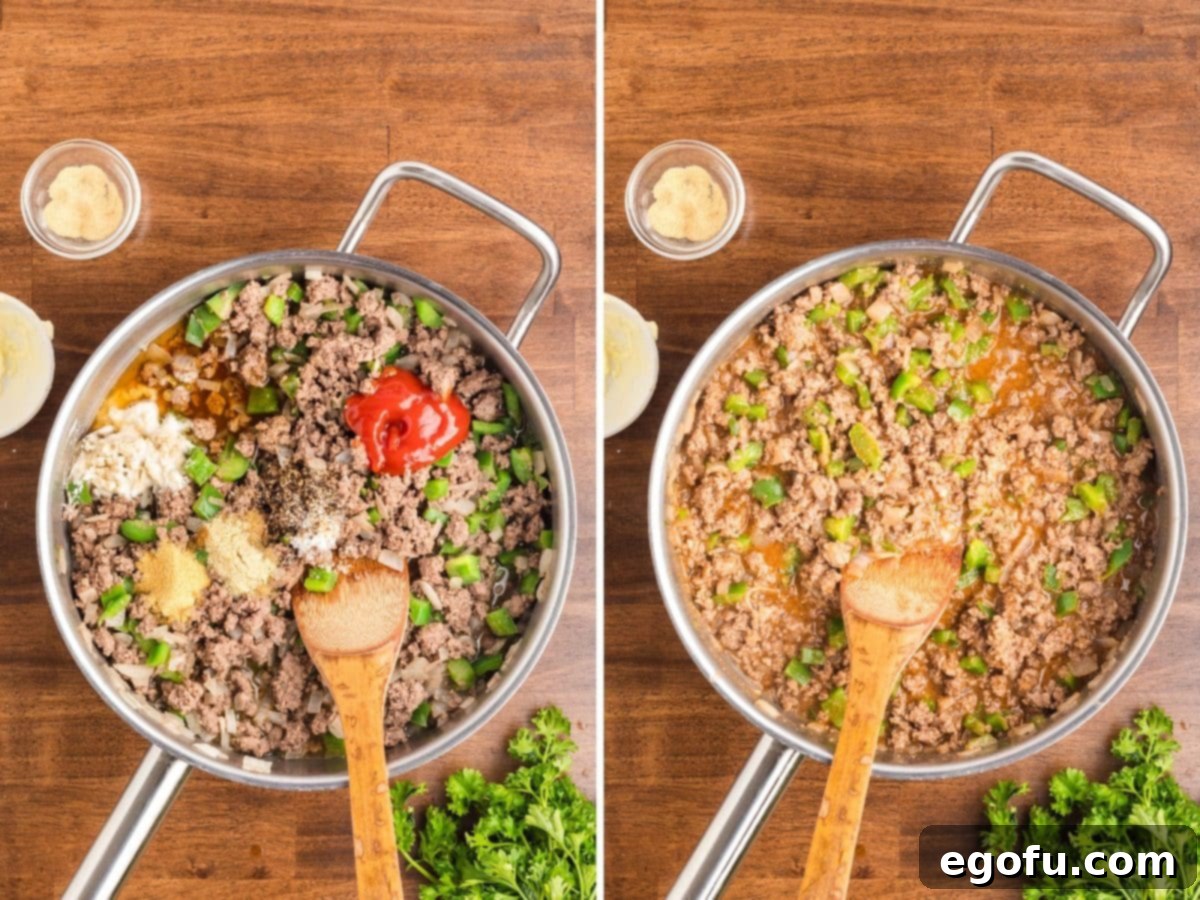 A skillet with onion, peppers, beef, beef broth, ketchup, Worcestershire sauce, dried ingredients, remainder of the garlic powder, and cornstarch. 