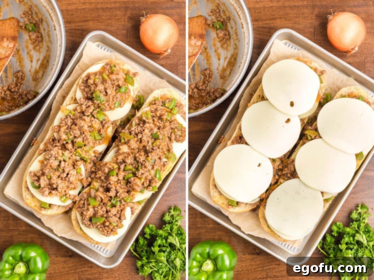 Layers of meat and cheese on an Italian loaf of bread. 