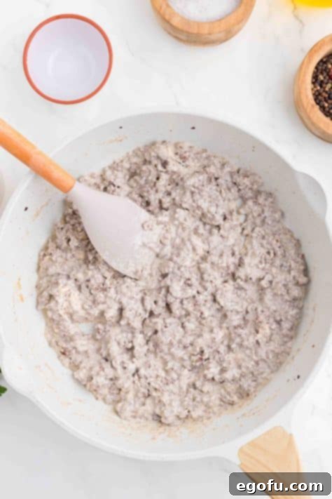 Thickened Alfredo sauce with ground beef.