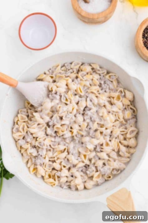 Ground Beef Alfredo sauce in skillet.