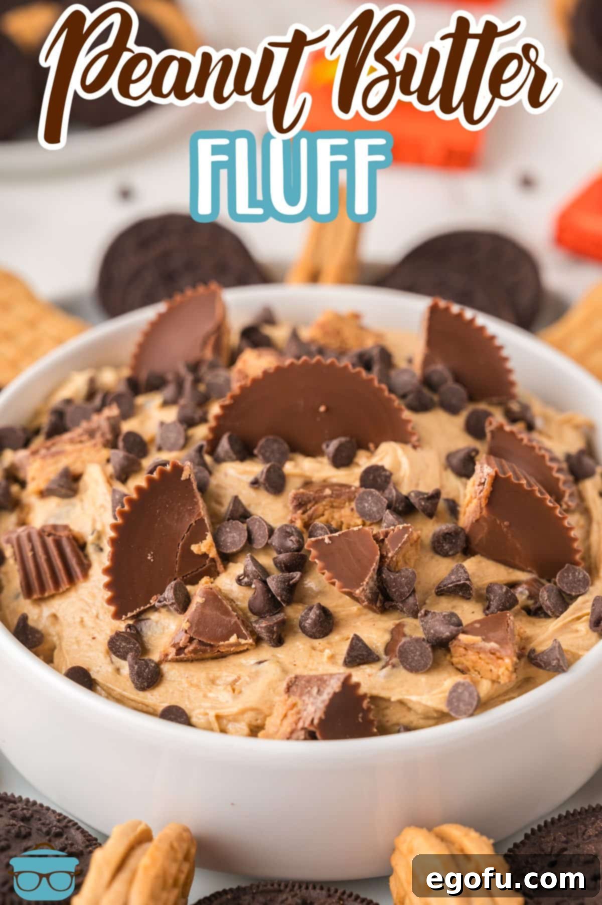 A large serving bowl filled with creamy Peanut Butter Fluff, topped with chocolate chips and chopped Reese's.