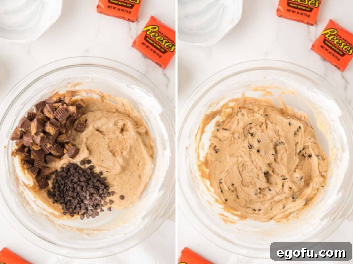 Chopped Reese's Peanut Butter Cups and mini chocolate chips being gently folded into the peanut butter fluff mixture.