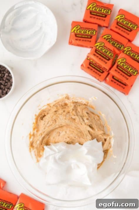 Cool Whip being added to the mixture.