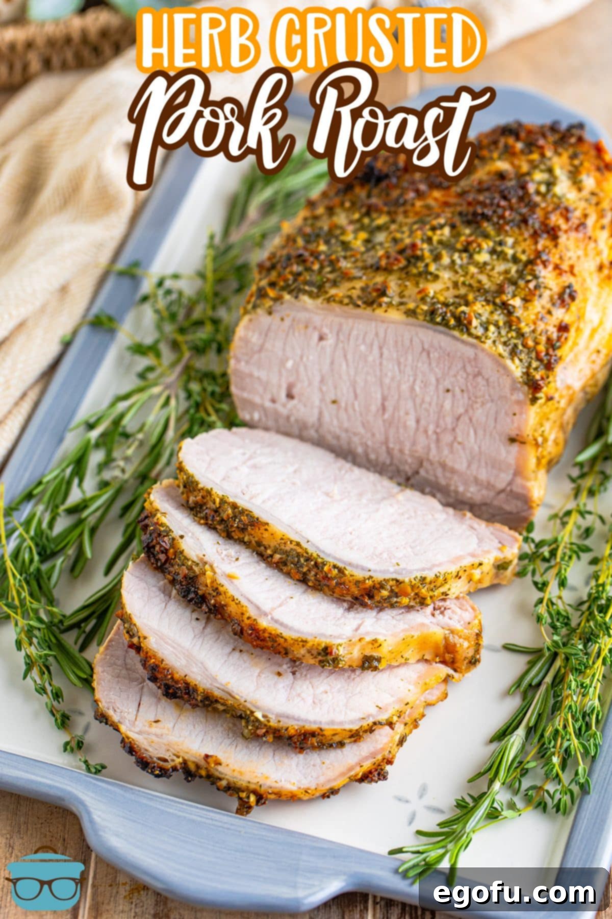 Looking down on a large, beautifully roasted Herb Crusted Pork Roast with a crispy herb crust.