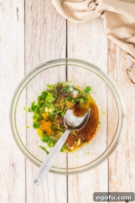 Zesty Cilantro-Lime Chicken 15 A bowl with cilantro, lime juice, lime zest, cumin, crushed red pepper, chili powder, honey, salt, pepper, garlic powder, and onion powder.