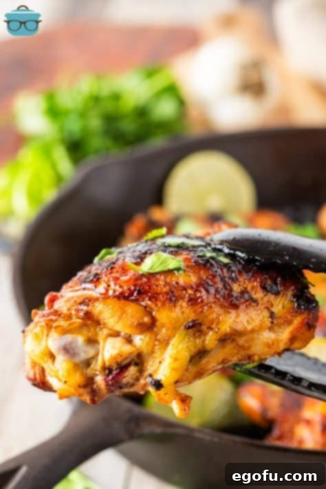 Zesty Cilantro-Lime Chicken 19 A pair of tongs holding a Cilantro Lime Chicken Thigh.