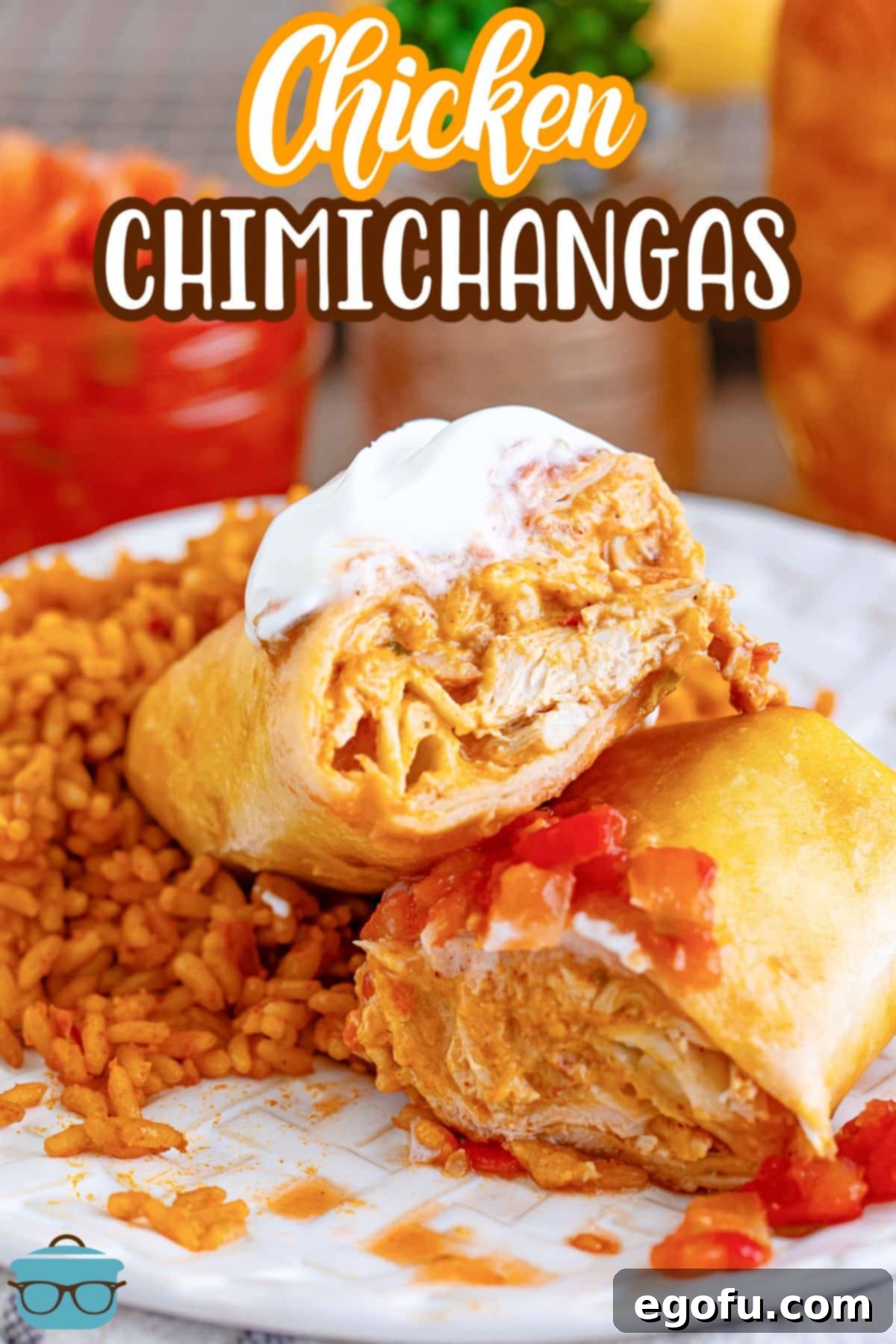 Two perfectly fried Chicken Chimichangas stacked on a plate, garnished with fresh toppings and accompanied by delicious side dishes.
