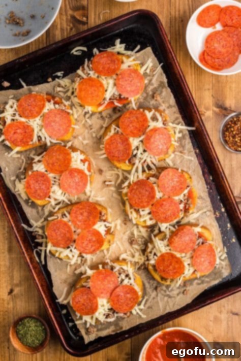Pepperoni slices, cheese, sauce, and garlic Texas Toast arranged on a sheet pan.