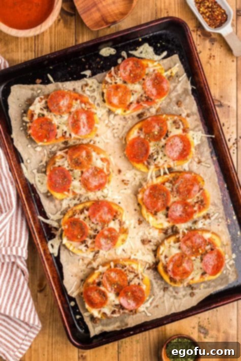 Melted Texas Toast Pizzas on a baking sheet, fresh out of the oven.