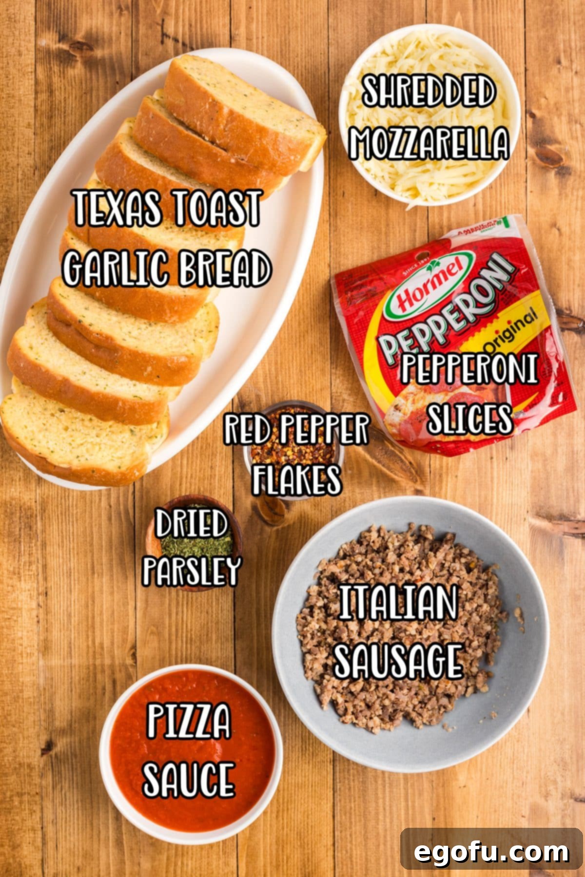 A vibrant flat lay of all the ingredients needed: Garlic Texas Toast, Italian sausage, red pepper flakes, pizza sauce, mozzarella cheese, pepperoni slices, and parsley.