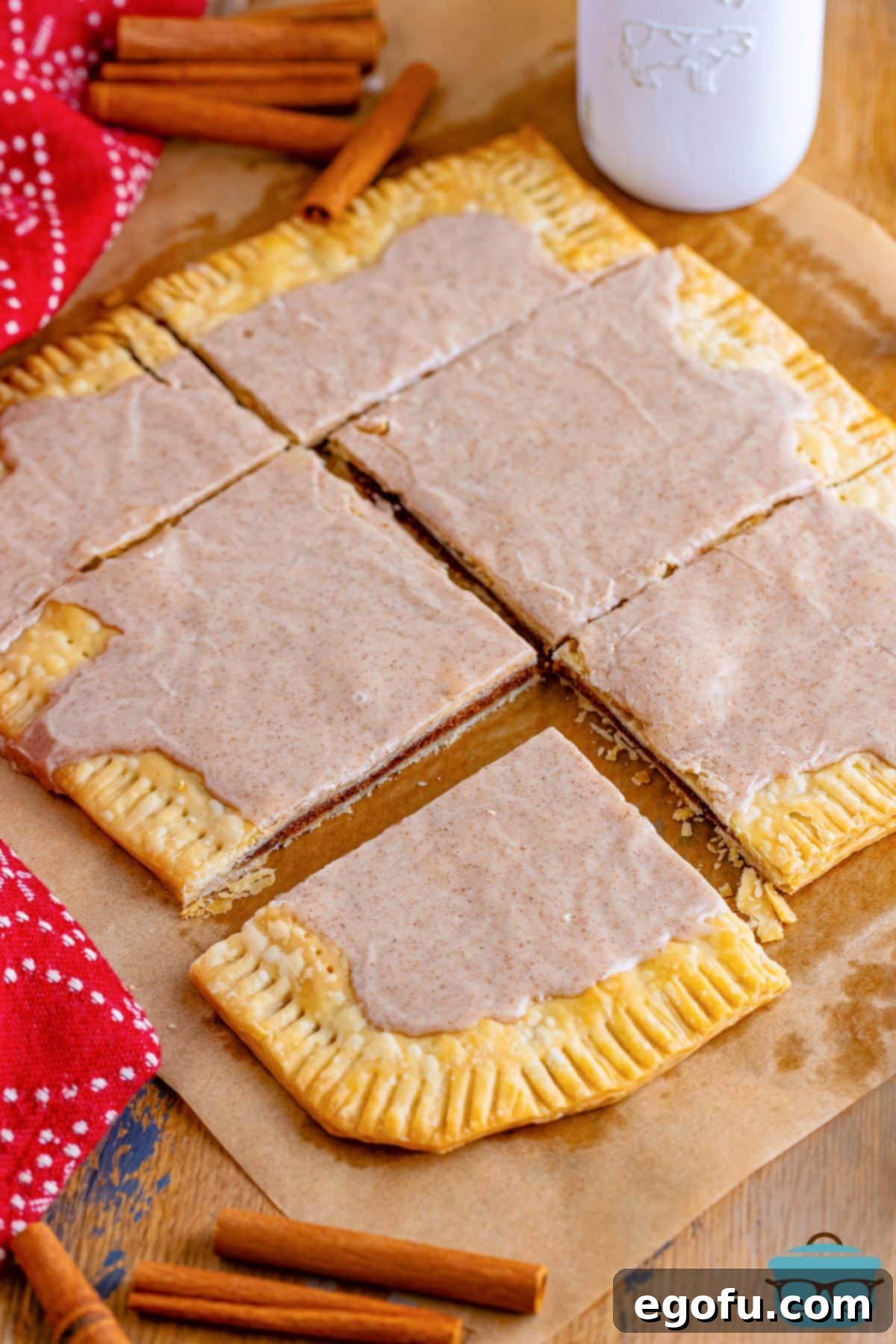 Six homemade Brown Sugar Pop Tarts on a piece of parchment paper, ready to be enjoyed.