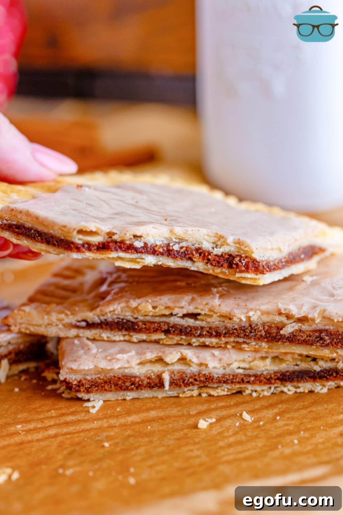 A freshly baked giant pop tart, golden brown and puffed, cooling on the baking sheet.