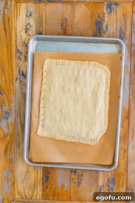 Crimped and rolled out pie crusts with brown sugar filling.