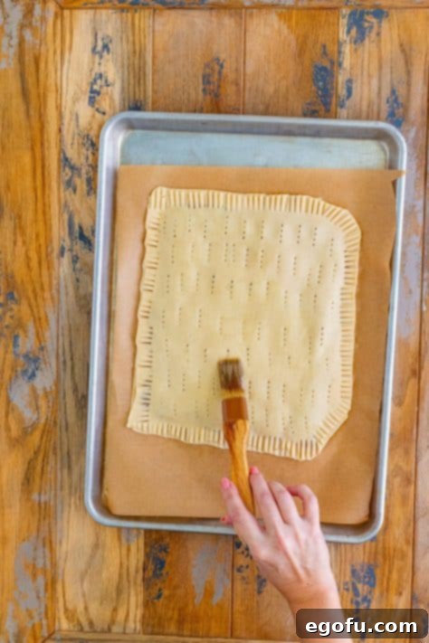 Melted butter being brushed over a giant pop tart.