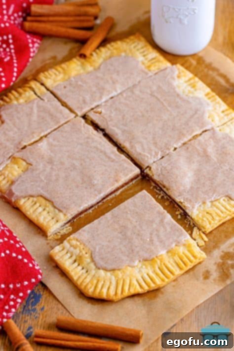 Six homemade Brown Sugar Pop Tarts on a piece of parchment paper.