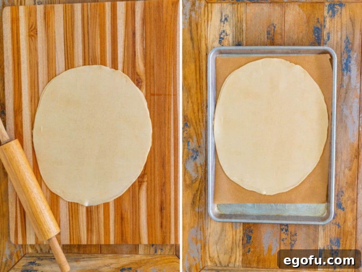 Two pie crusts rolled out together on a piece of parchment paper.