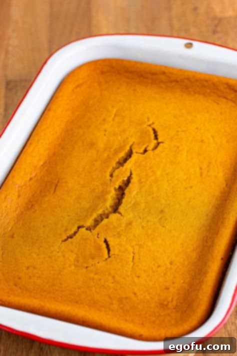 Decadent Pumpkin Pie Cake 12 A freshly baked Pumpkin Pie Cake, still in the pan and un-frosted, displaying its golden-brown top.