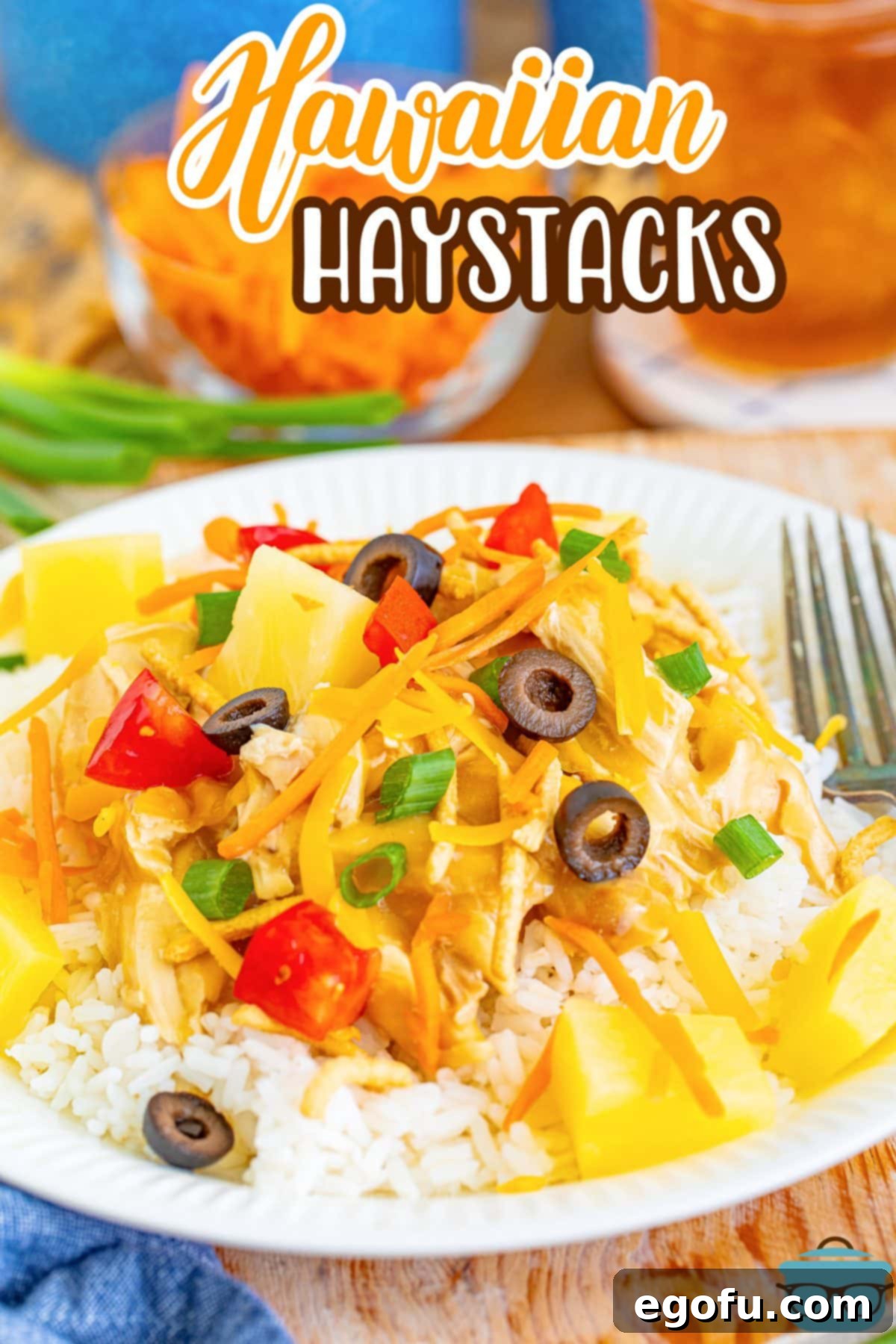 Island Topping Towers 3 A closer view of a serving of Hawaiian Haystacks, highlighting the detailed layers and vibrant variety of toppings on a dinner plate.