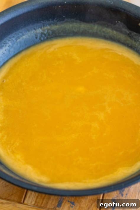 Island Topping Towers 8 Chicken gravy being prepared in a skillet.