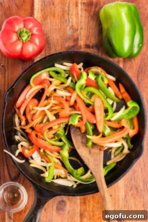 Effortless Arroz con Pollo 9 Peppers and onions in a skillet.