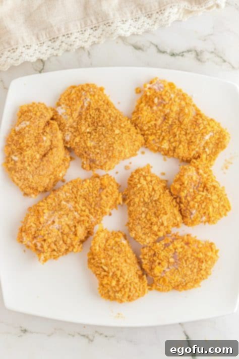 Coated chicken pieces on a plate.