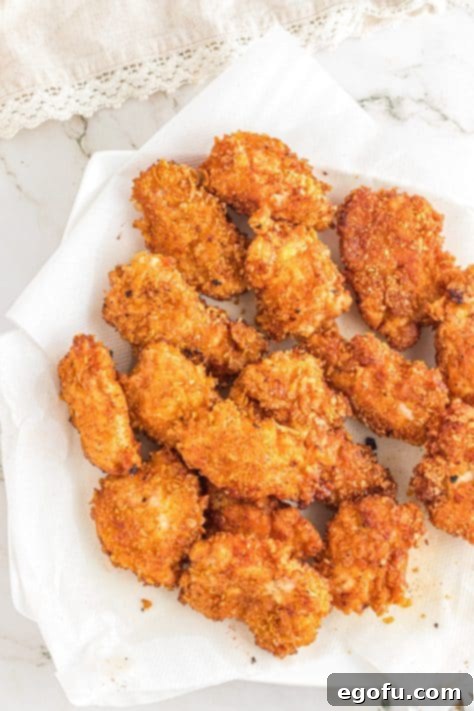 Freshly fried chicken wings on paper towels.
