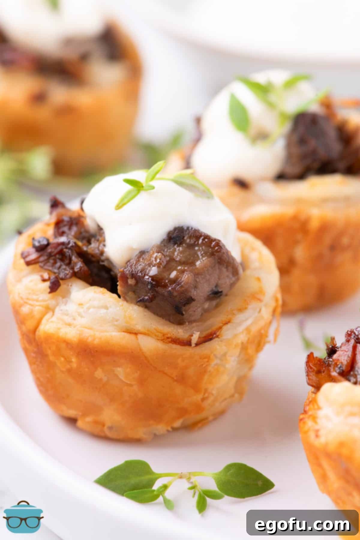 A cute Beef Wellington Bite with a dollop of Horseradish Cream sauce.