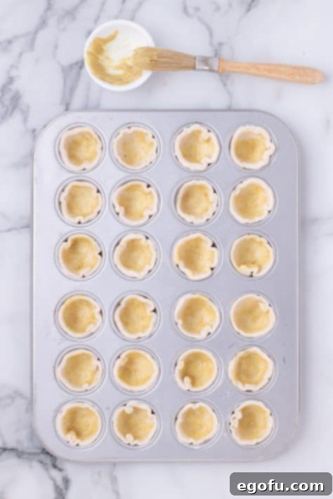 Dijon mustard brushed all over puff pastry pieces.