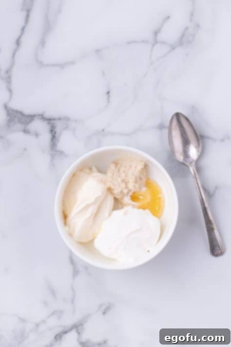 Horse radish cream sauce to be mixed in a bowl.