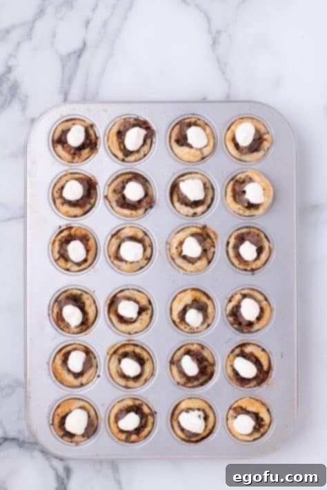 Dollops of horseradish cream sauce on top of Beef Wellington Bites.