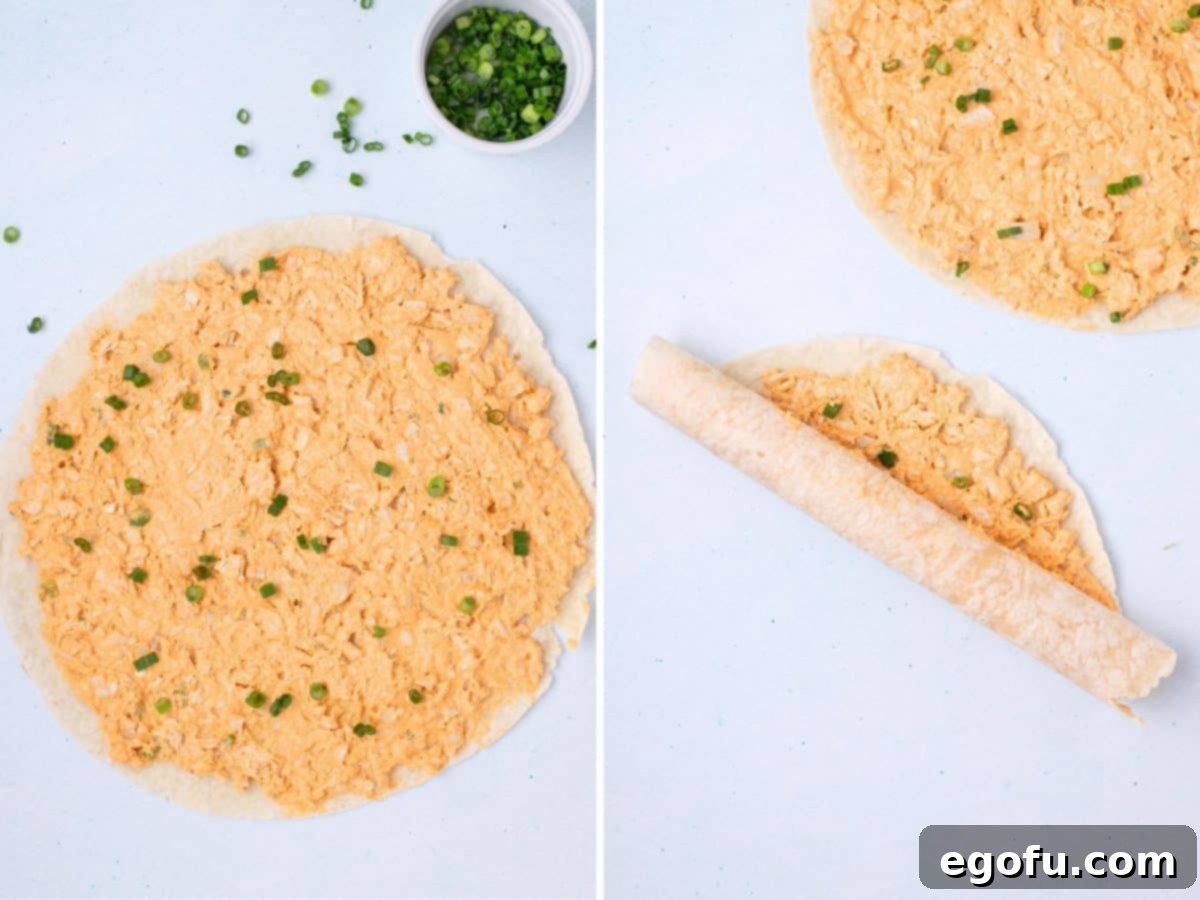 Green onions being sprinkled over the chicken mixture and the tortilla being rolled up.