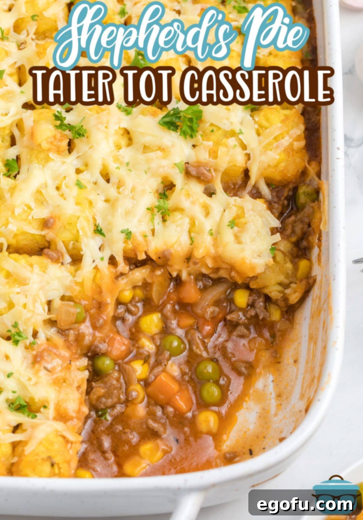 Looking down on the corner of a baking dish with Shepherd's Pie Tater Tot Casserole.