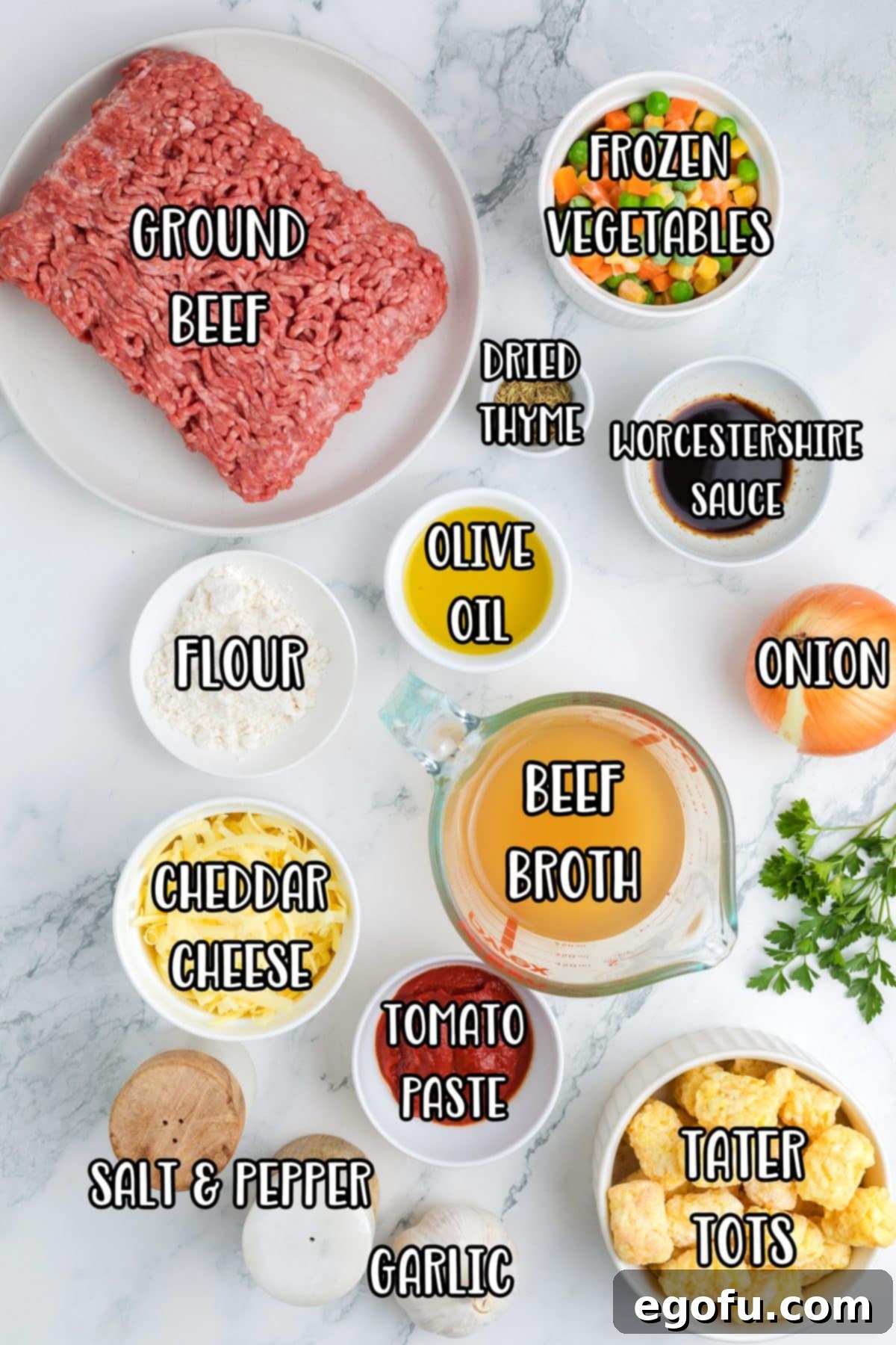 Ground beef, onion, garlic, olive oil, tomato paste, all purpose flour, beef broth, frozen veggies, Worcestershire sauce, thyme, salt, pepper, tater tots, cheddar cheese, and parsley.