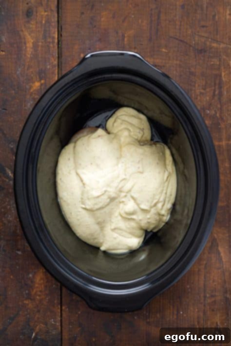 Effortless Slow Cooker Angel Chicken 14 Sauce over the seared chicken in a Slow Cooker.