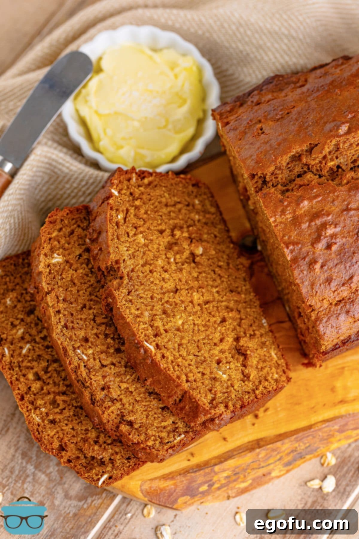 Ireland's Beloved Brown Loaf 7 A freshly baked loaf of Irish Brown Bread resting on a cutting board, with several slices already cut, revealing its wholesome interior.