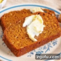 Ireland's Beloved Brown Loaf 8 A slice of Irish Brown Bread with a smear of butter on it, presented invitingly.
