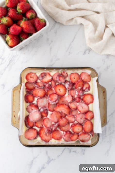 Luscious Strawberry Crumble Cheesecake Squares 10 Freshly chopped strawberries tossed with sugar and cornstarch, ready to be spread over the creamy cheesecake layer.
