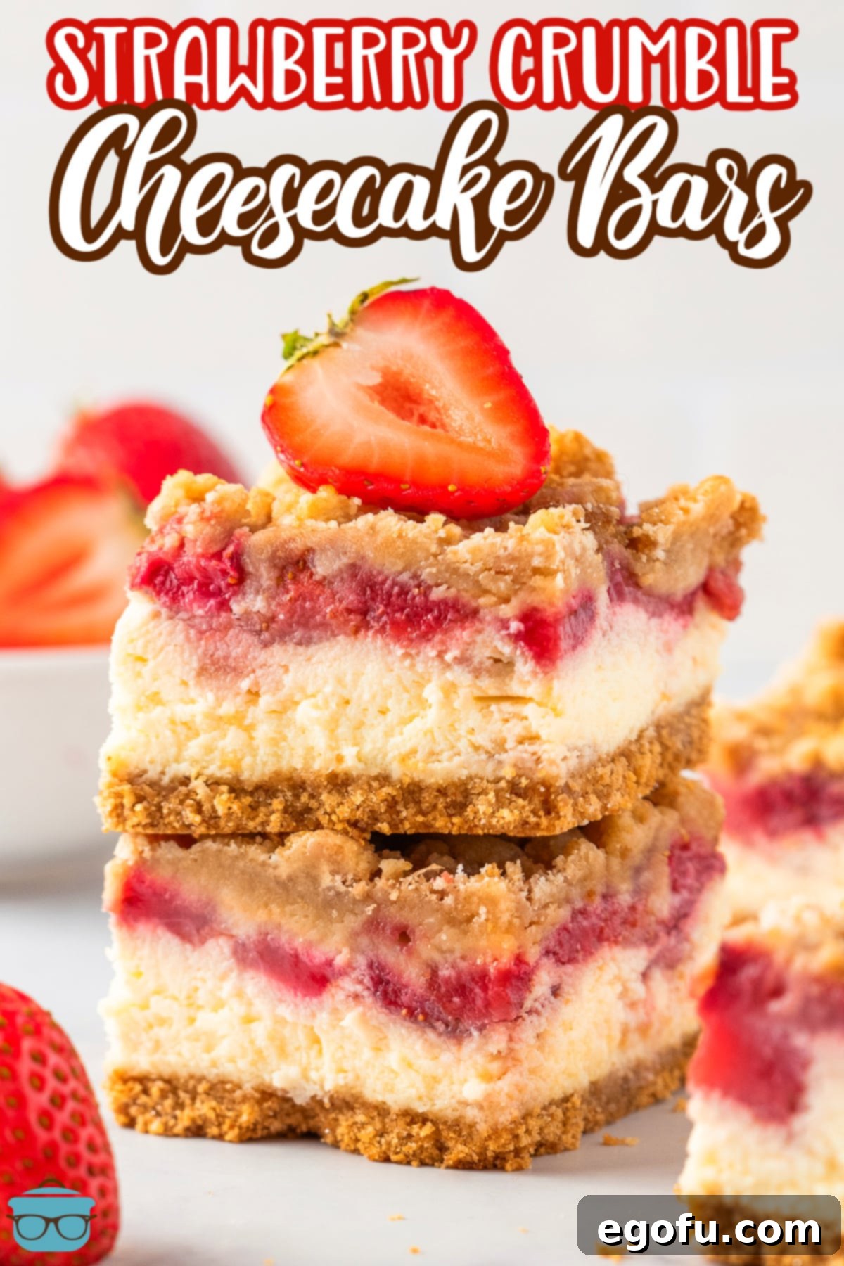 Luscious Strawberry Crumble Cheesecake Squares 3 Two decadently layered Strawberry Crumble Cheesecake Bars, one atop the other, showcasing their irresistible layers of crust, cheesecake, strawberries, and crumble.