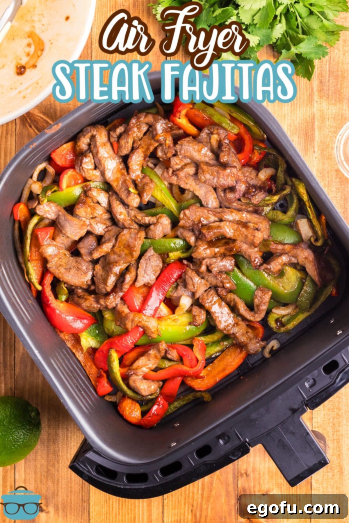 Looking down on an open Air Fryer basket with Air Fryer Steak Fajitas.