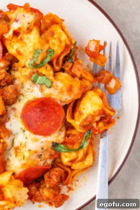 A plate of Pizza Tortellini with a fork.