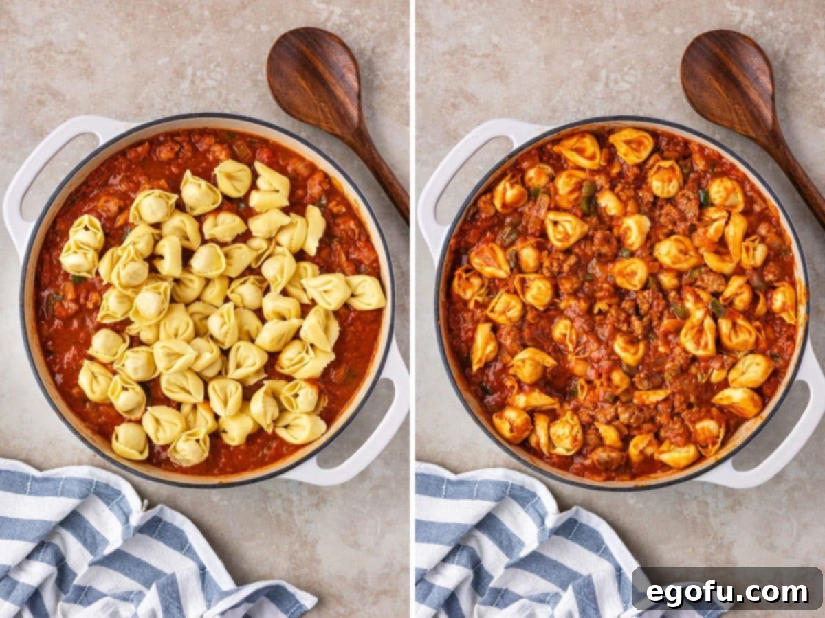 Tortellini added to a sauce and veggie skillet, all mixed together and ready for the next step.