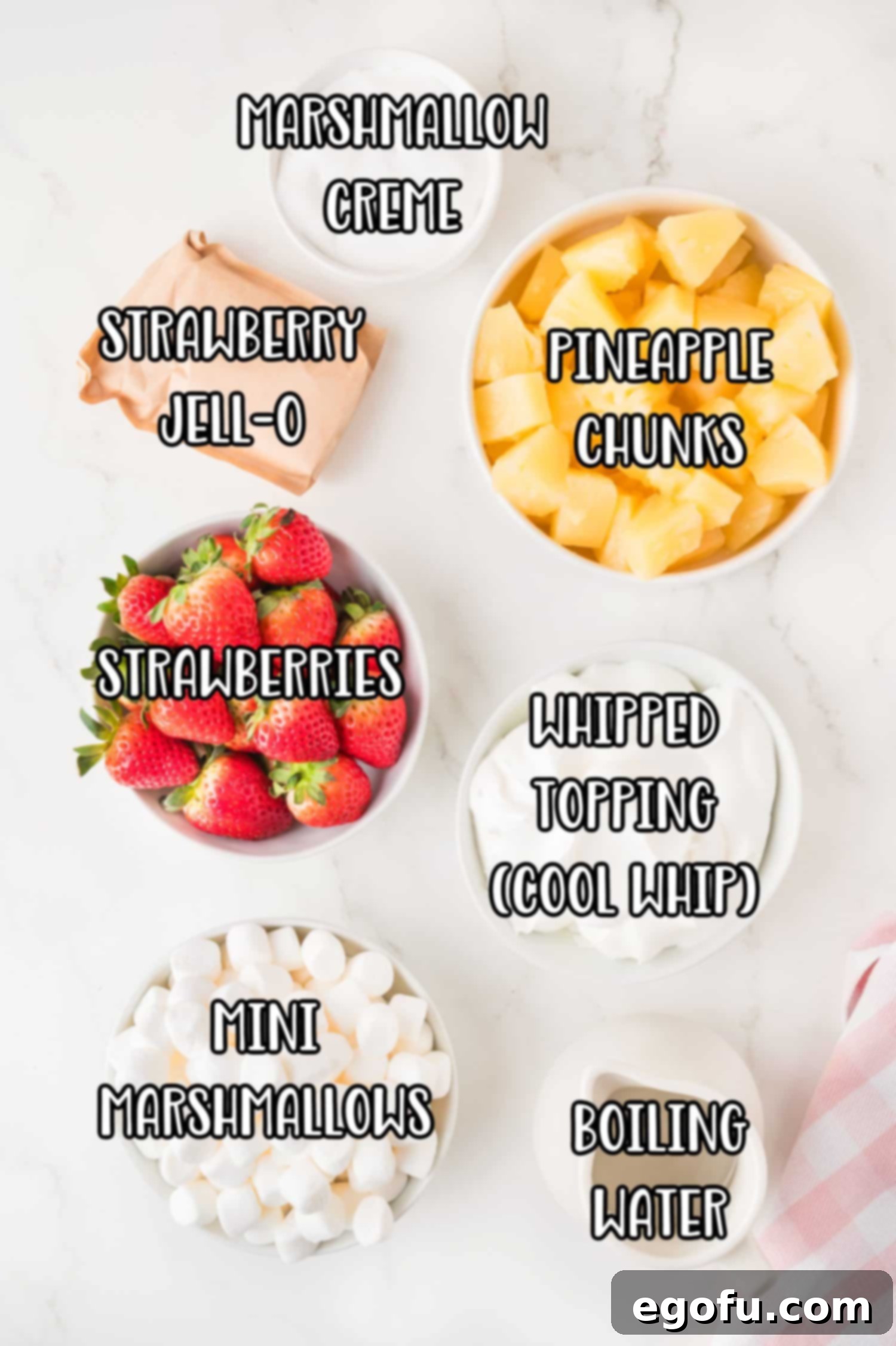Strawberries, pine apple chunks, marshmallow creme, strawberry jello powder, whipped topping, mini marshmallows, and boiling water.