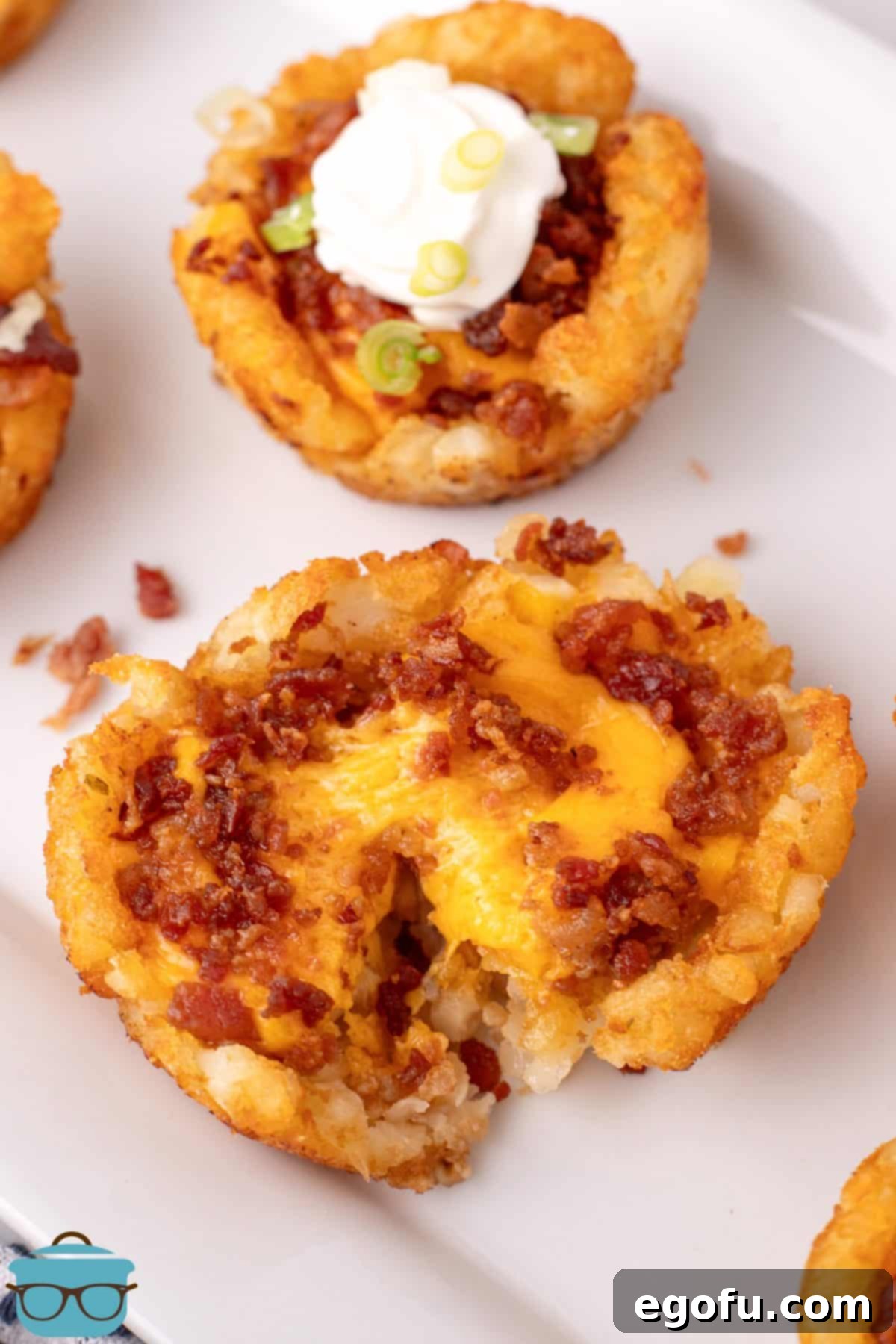 Looking down on a Loaded Tater Tot Cup closely, showcasing its crispy edges and melted cheese.