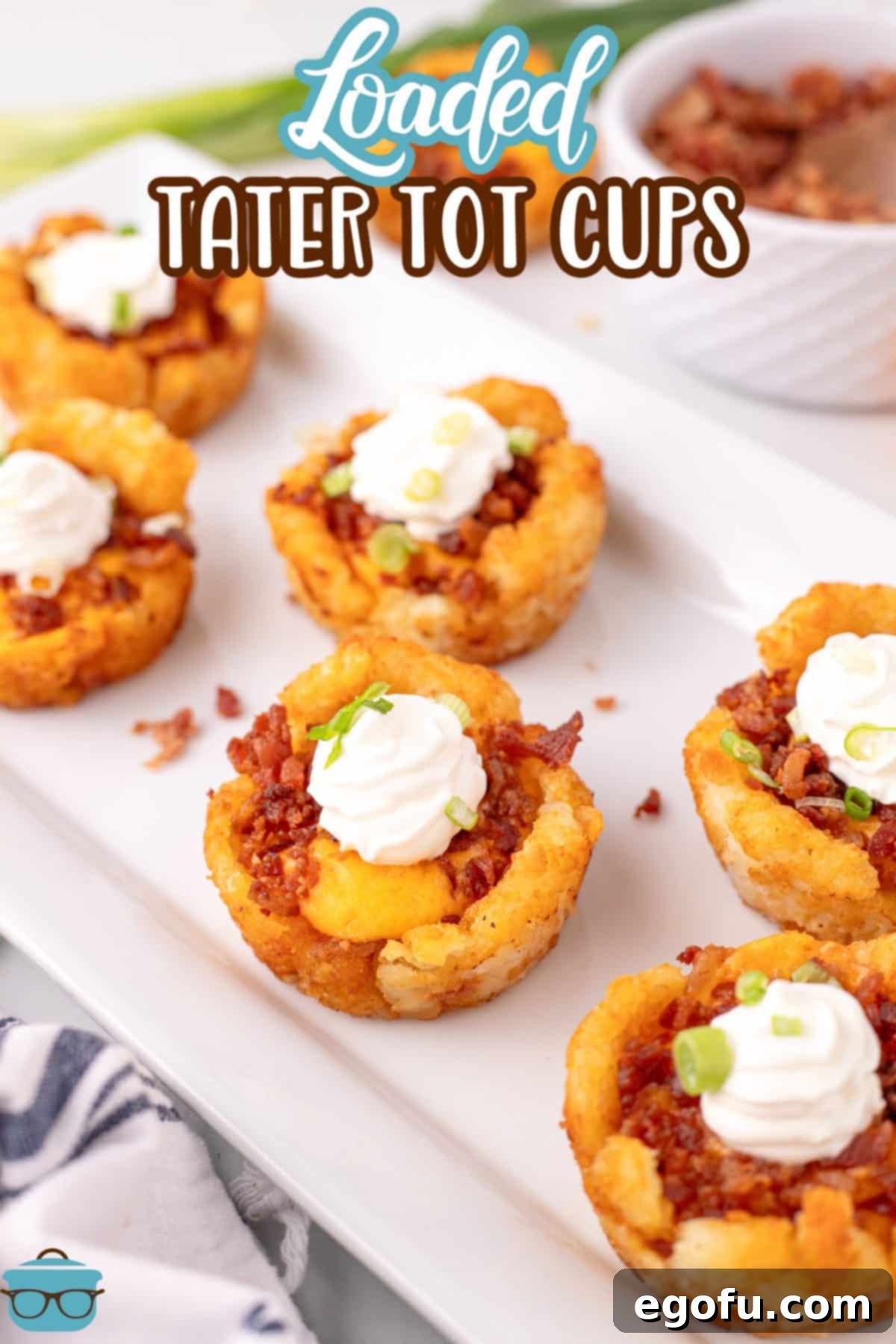 A few perfectly golden and cheesy Loaded Tater Tot Cups arranged on a serving tray.